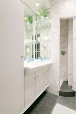a white bathroom with a sink and a shower at Le Corail, Suquet pedestrian area, Cannes in Cannes