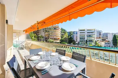 a table and chairs on a balcony with a view at Lacour - 2 bedroom apartment - Large terrace - 2 min from the Croisette & beaches in Cannes