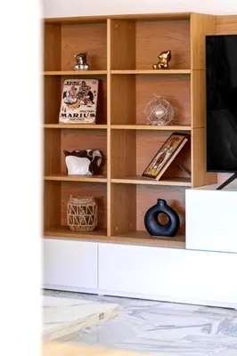 a wooden book shelf with a tv in a living room at Lacour - 2 bedroom apartment - Large terrace - 2 min from the Croisette & beaches in Cannes