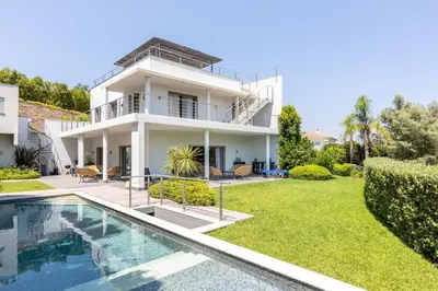 a house with a swimming pool in front of it at Luxury Two-Storey Villa with Pool & Rooftop Peaceful Setting Near Cannes in Cannes