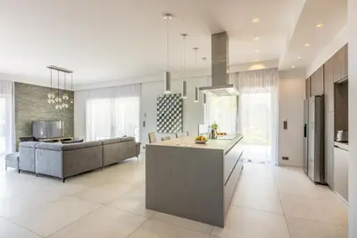 a large kitchen and living room with a couch at Luxury Two-Storey Villa with Pool & Rooftop Peaceful Setting Near Cannes in Cannes