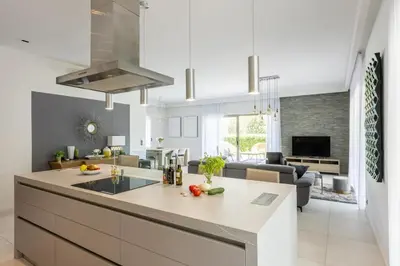 a kitchen and living room with a large island in a kitchen at Luxury Two-Storey Villa with Pool & Rooftop Peaceful Setting Near Cannes in Cannes