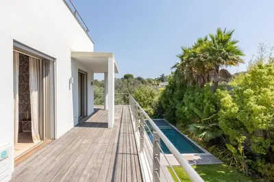 a wooden walkway leading to the balcony of a house at Luxury Two-Storey Villa with Pool & Rooftop Peaceful Setting Near Cannes in Cannes