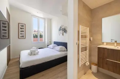 a small bedroom with a bed and a window at Modern Apartment a c 2CH 4P - Cannes in Cannes