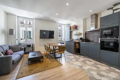 a kitchen and living room with a couch and a table at Modern Apartment a c 2CH 4P - Cannes in Cannes