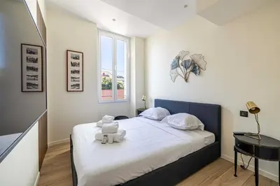 a bedroom with a bed with a teddy bear on it at Modern Apartment a c 2CH 4P - Cannes in Cannes