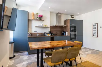a kitchen with a wooden table and chairs at Modern Apartment a c 2CH 4P - Cannes in Cannes