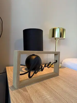 a wooden box with a ball in it on a table at Art apart studio Rouaze in Cannes