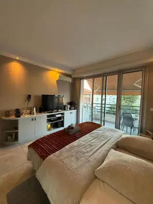 a large bedroom with a large bed and a balcony at Art apart studio Rouaze in Cannes