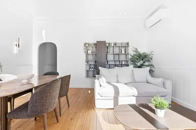 a living room with a white couch and a table at Riviera signature apartment by Welcome to Cannes in Cannes