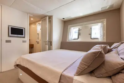 a bedroom with a large bed and a bathroom at Yacht Mangusta in Cannes