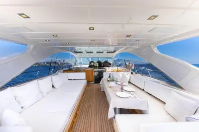 a boat with white seats and a table at Yacht Mangusta in Cannes