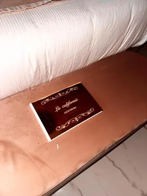 a white bed with two towels and flowers on it at California Romantic Suite with Balneo in Cannes