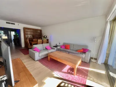 a living room with two couches and a coffee table at June apartment 2 bedrooms with pool in Cannes