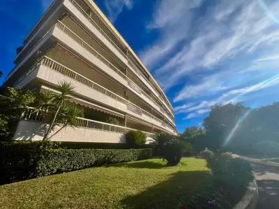 a building with a green lawn in front of it at June apartment 2 bedrooms with pool in Cannes