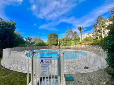 a basketball hoop in a park with a blue sky at June apartment 2 bedrooms with pool in Cannes