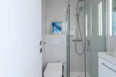 a bathroom with a shower and a toilet and a sink at 2-Br Sea-View Apartment Residence with Swimming Pool Cannes in Cannes