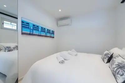 a white bedroom with a bed and a window at 2-Br Sea-View Apartment Residence with Swimming Pool Cannes in Cannes