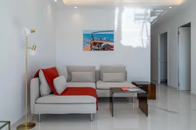 a living room with a couch and a table at 2-Br Sea-View Apartment Residence with Swimming Pool Cannes in Cannes