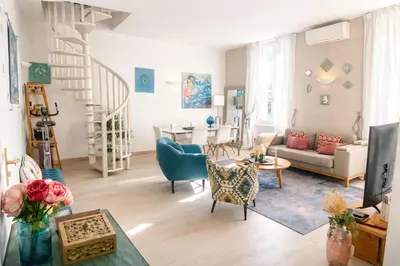 a living room with a couch and a table at Cozystay 1825 Luxury Duplex on Rue dAntibes in Cannes