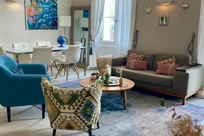 a living room with a couch and a table at Cozystay 1825 Luxury Duplex on Rue dAntibes in Cannes