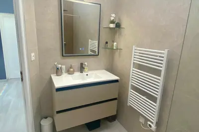 a bathroom with a white sink and a mirror at Cozystay 1825 Luxury Duplex on Rue dAntibes in Cannes