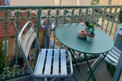a table and a chair on a balcony at Cozystay 1825 Luxury Duplex on Rue dAntibes in Cannes