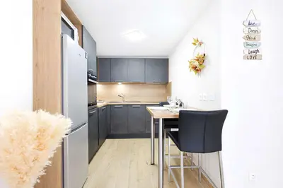 a small kitchen with a table and chairs in it at Sud Croisette - Proche Palais des Festivals in Cannes