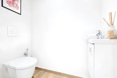 a white bathroom with a toilet and a sink at Sud Croisette - Proche Palais des Festivals in Cannes