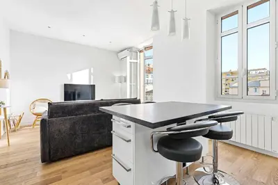 a kitchen and living room with a counter and stools at Le Rosy - Apartment in Central Cannes Balcony in Cannes