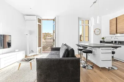 a kitchen and living room with a couch and a table at Le Rosy - Apartment in Central Cannes Balcony in Cannes