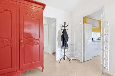a red cabinet in a room with a kitchen at Jardin Suquet - Appartement panoramique Grande terrasse vue sur mer & Palais in Cannes