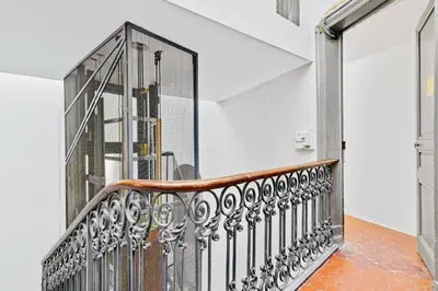 a staircase with a metal railing in a house at Suite Azur - Appartement en plein centre de Cannes - Climatisation - Wifi - Proche du Palais des Festivals et des Commerces in Cannes
