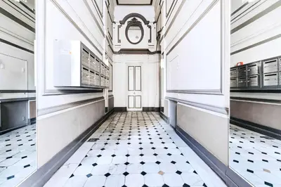 a kitchen with a black and white tiled floor at Suite Azur - Appartement en plein centre de Cannes - Climatisation - Wifi - Proche du Palais des Festivals et des Commerces in Cannes