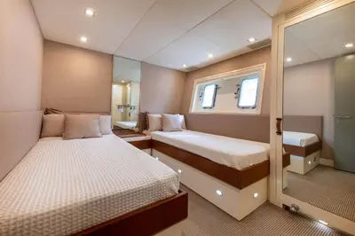 a small bedroom with two beds and a mirror at Votre Palace Flottant sur la Croisette à Cannes in Cannes