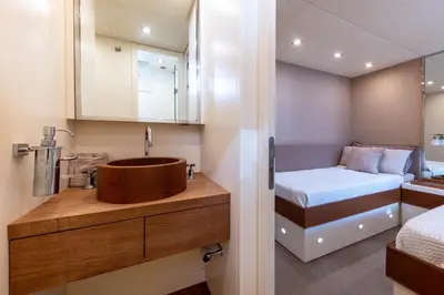 a small bathroom with a sink and a bed at Votre Palace Flottant sur la Croisette à Cannes in Cannes