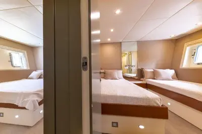 two beds in a room with two windows at Votre Palace Flottant sur la Croisette à Cannes in Cannes