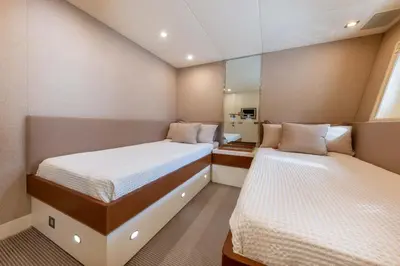 two beds in a small room with a mirror at Votre Palace Flottant sur la Croisette à Cannes in Cannes