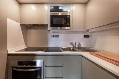 a kitchen with a sink and a microwave at Votre Palace Flottant sur la Croisette à Cannes in Cannes