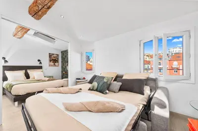 a bedroom with two beds and a couch at Coeur de ville - Charmant appartement rénové - FS in Cannes