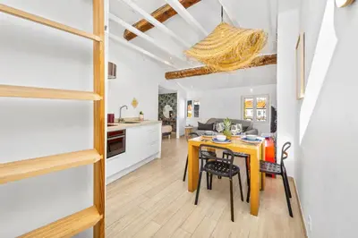 a kitchen and dining room with a yellow table and chairs at Coeur de ville - Charmant appartement rénové - FS in Cannes