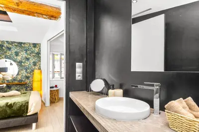 a bathroom with a sink and a mirror at Coeur de ville - Charmant appartement rénové - FS in Cannes
