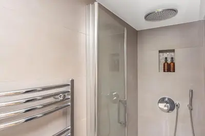 a bathroom with a shower with a glass door at Coeur de ville - Charmant appartement rénové - FS in Cannes