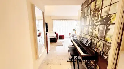 a room with a piano and a living room at Pointe Croisette, 2 chambres - Exclusivité Congrès - Palmazur Vacances in Cannes