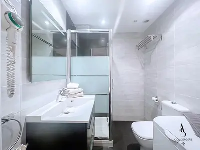 a white bathroom with a sink and a toilet at Le Narval - Studio - Croisette - Proche Palais in Cannes
