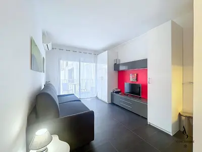 a living room with a couch and a television at Le Narval - Studio - Croisette - Proche Palais in Cannes