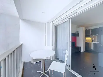 a small white table and chairs in a room at Le Narval - Studio - Croisette - Proche Palais in Cannes