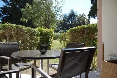 a table and chairs sitting on a patio at Cannes, garden level, pool, nearby beaches in Cannes