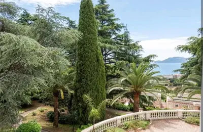 a view of a garden with trees and a bridge at Cannes, garden level, pool, nearby beaches in Cannes