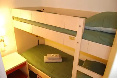a bunk bed with a purse on the bottom bunk at Cannes, garden level, pool, nearby beaches in Cannes